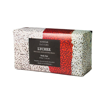 Soap bar with red and white pattern and black label on a white background.