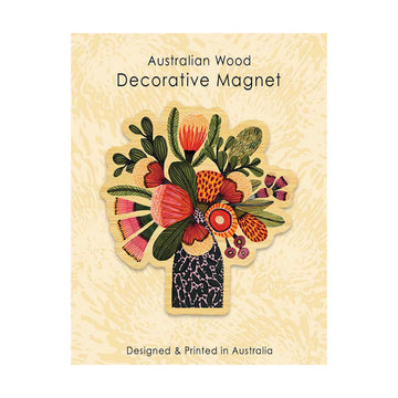 Decorative wooden magnet with floral design on a textured beige background.