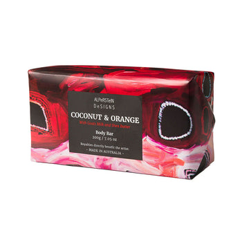 A bar of soap wrapped in paper with red artwork.