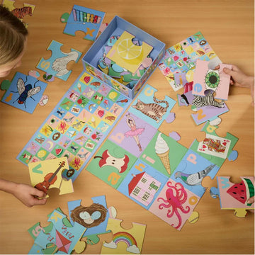 A puzzle box titled 'Alphabet Floor Puzzle' with letters and images matching the letter including an apple, cat and icecream. 