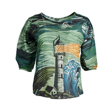 A women's blouse with half length sleeves and illustrated with an abstract lighthouse in green, yellow and blue.