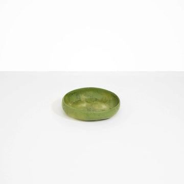 A small shallow bowl in olive green resin.