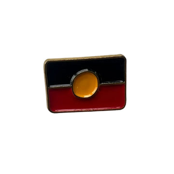 An enamel charm shaped, printed and engraved with the Aboriginal flag.
