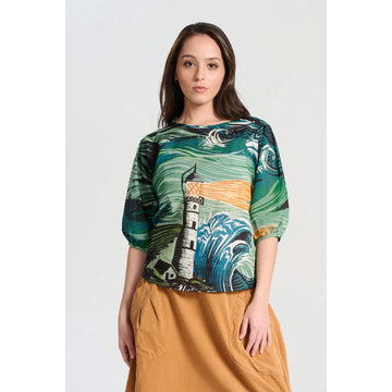 A women's blouse with half length sleeves and illustrated with an abstract lighthouse in green, yellow and blue.