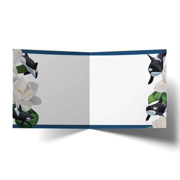 A square greeting card with illustrations of whales and flowers.