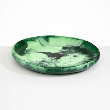 A large shallow bowl in moss green resin.
