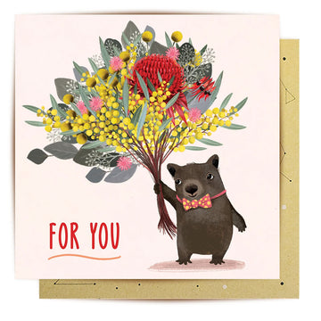A square greeting card with an illustration of a wombat holding a bunch of flowers with the text 'For You'.