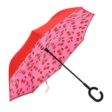 Inverted umbrella with cherry pattern on a pink background.