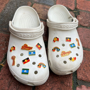 An enamel charm shaped and engraved with the Torres Strait Islander flag.