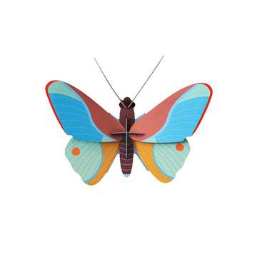 A cardboard model of a butterfly in blue, red and orange.