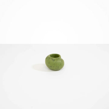 A small abstract shaped round vase in olive green resin.