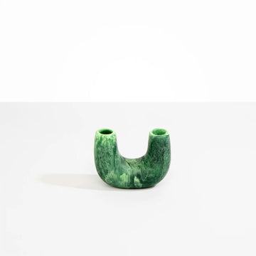 A U shaped vase in moss green resin.