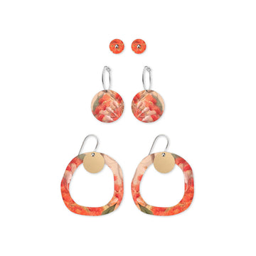 Three sets of earrings with floral design on a white background.