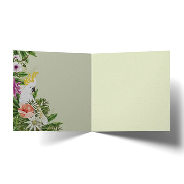 Card with two cockatoos and tropical flowers on a scenic background.