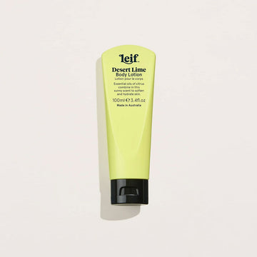 A yellow green tube of hand cream with a black lid and text on the front titled 'Desert Lime Body Lotion'.