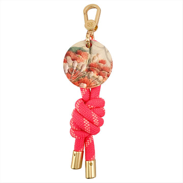Keychain with pink rope and gold accents on a white background.