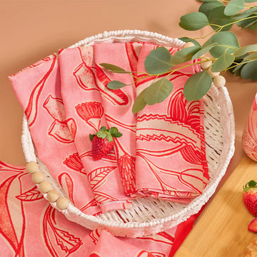 Pack of pink napkins with red patterns and a visible brand label on a white background.