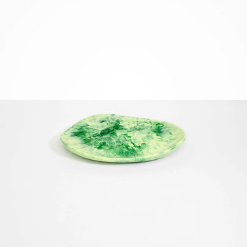 An irregular shaped resin platter in green.