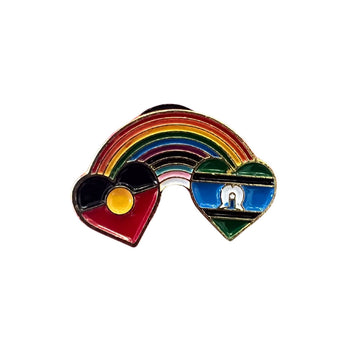 An enamel pin with the Aboriginal flag and Torres Strait Islander flags in hearts and connected with a rainbow.