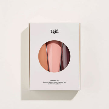 Three tubes of hand cream inside a white box with a circle cut out in the middle.