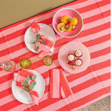 Red and pink striped tablecloth with a brown label on a white background.
