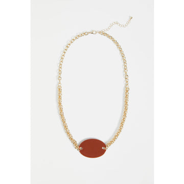 An image of a gold necklace with a gloss oval pendant in a deep spice colour.