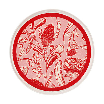 Decorative plate with red floral pattern on a white background.
