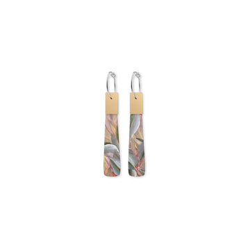 Pair of earrings with floral design on a beige background.