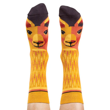 A pair of socks printed with kangaroo faces are being worn.