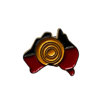 An enamel pin shaped like Australia and printed and engraved with the Aboriginal flag.