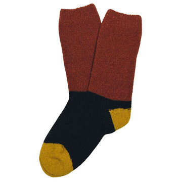 A pair of socks featuring rust on the leg part, black on the sole part and mustard on the heel and toe.