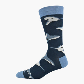 A navy blue sock with a lighter blue heel, toe and cuff and illustrations of sharks.