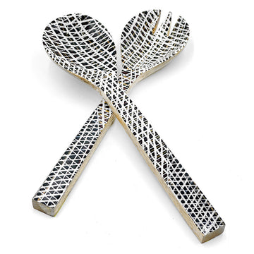 A pair of wooden salad servers printed with artwork by Paulina Puruntatamerion the front.