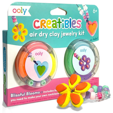 A box titled 'Creatibles Air Dry Clay Jewellery Kit' with two clear pots filled with coloured clay and beads on the front and a completed bracelet with a yellow and orange clay flower and beads.