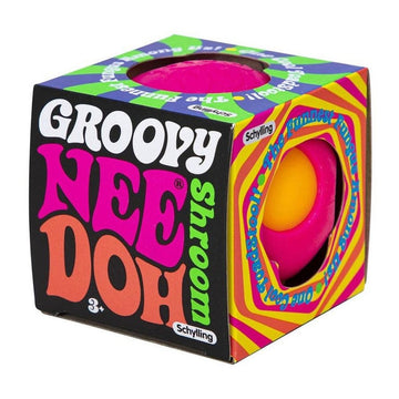 A pink and yellow squish toy inside a box with cut outs and the heading 'Groovy Nee Doh Shroom' on one side of the box.