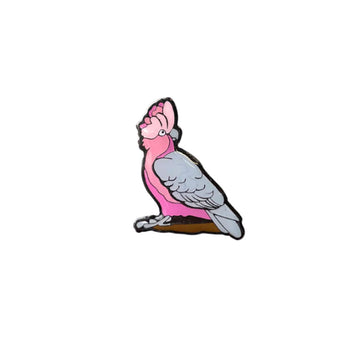 An enamel badge shaped like a galah.