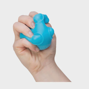 A cube box with the text 'Happy Nee Doh Snappy' on the front and circle cut outs on the sides.