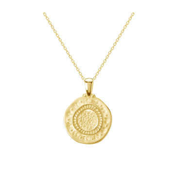 A round pendant in gold with etchings on a gold chain.