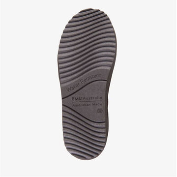 Tan suede boot with a black sole on a white background.