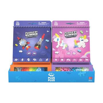 Two Plus Plus puzzle by number activity pads in blue and pink with colorful pieces on a white background.