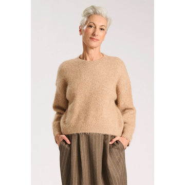 A beige knitted sweater on a white background.