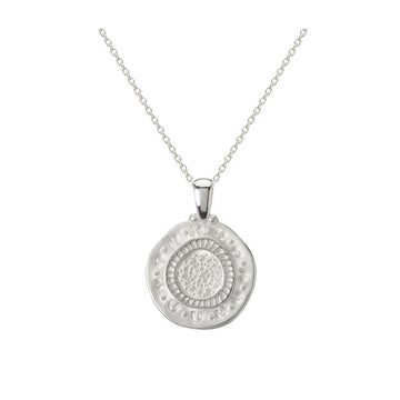 A rounded silver pendant with etchings on a silver chain necklace. 