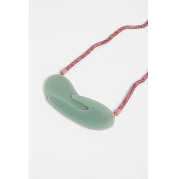 An image of a pink necklace with a green pendant.