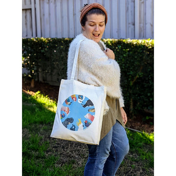 A folded up calico tote bag illustrated with birds.