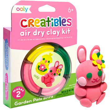 A box titled 'Creatibles Air Dry Clay Kit' with a cut out showing a clear container filled with coloured clay. There is a completed clay bunny status in front of the box.