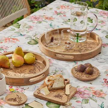 A wooden tray with cut out handles and an etch design of a bee and leaves.