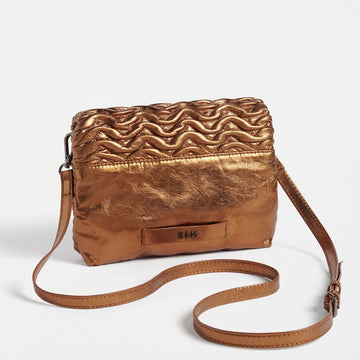 Front view of a rectangle cross body bag with an embossed wave pattern across the bag.