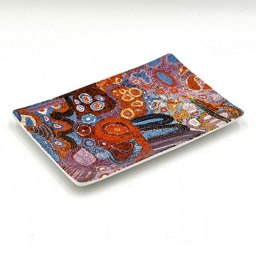 A ceramic rectangle tray printed with artwork by Andrea Adamson.