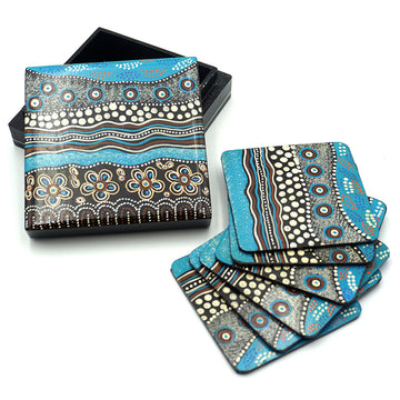 A set of six coasters and matching box printed with artwork by Bianca Gardiner-Dodd in blue and brown.
