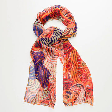 A sheer scarf printed with artwork by Nora Davidson in orange and blue.